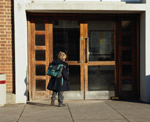 Young boy going into school