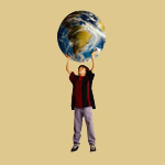 Young boy holding globe over his head
