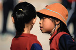 Two girls whispering