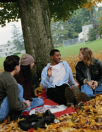 Group talking while sitting under tree