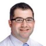 A person smiling for a professional headshot.