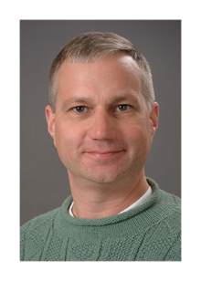 A person smiling for a professional headshot.
