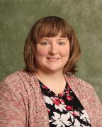 A person smiling for a professional headshot.