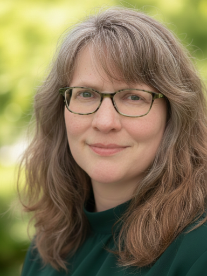 A person smiling for a professional headshot.