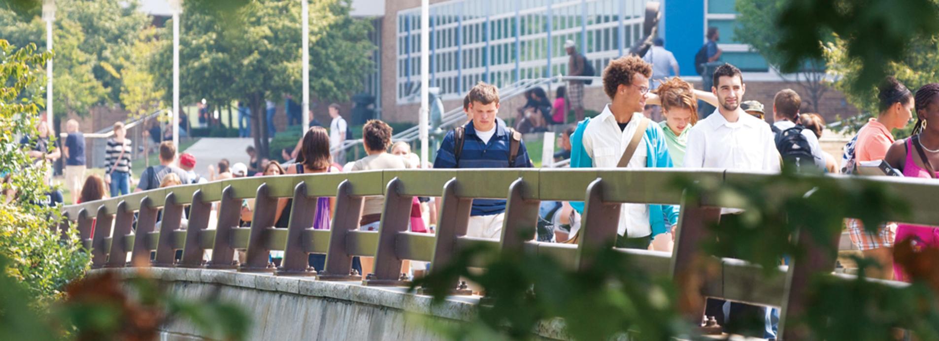 Onondaga students going to class across bridge