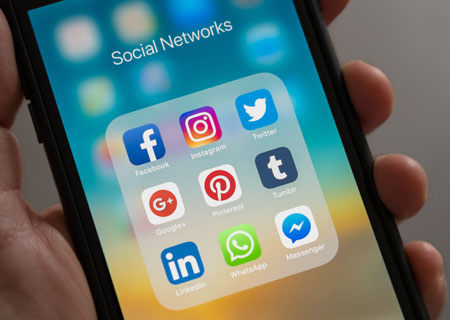 Social media icons on smartphone screen.