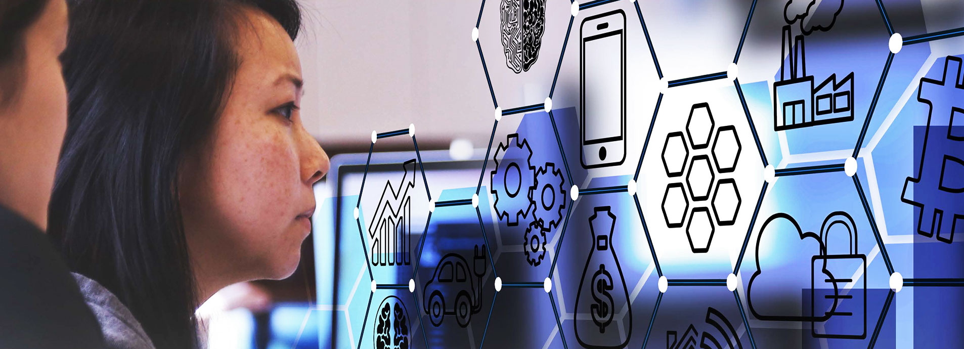 Asian woman looking at screen while coding.