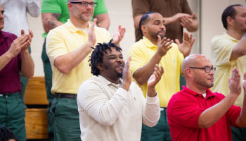 Males standing up and clapping