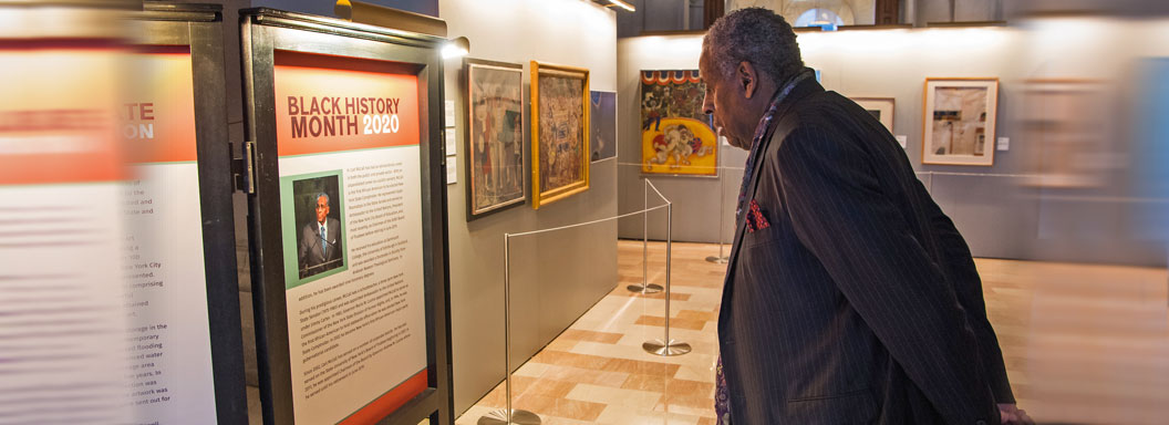 SUNY Board Chairman Emeritus H. Carl McCall views an exhibit in the War Room of the New York State Capitol honoring himself and Black History Month.