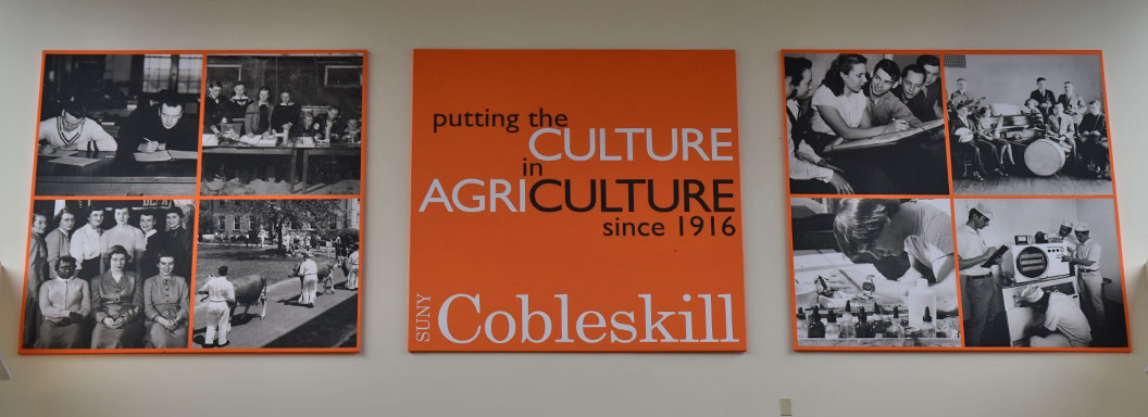 Large banner hanging on wall saying Putting the Culture in Agriculture since 1916 at SUNY Cobleskill.