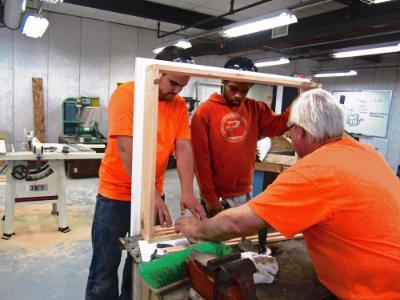 Students at the Troy EOC participate in a carpentry building trades class with a teacher. 