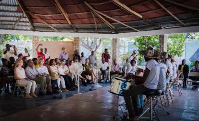 Haitian students put on a drumming show for SUNY officials and locals in Akaye, Haiti. 
