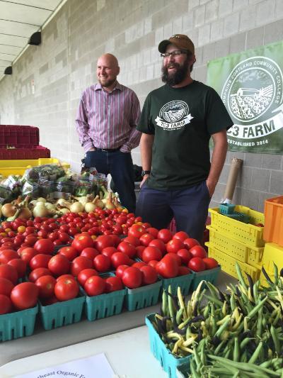 Staff from Tompkins Cortland Community College working a farm stand.