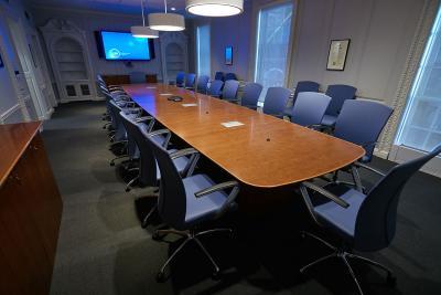  The boardroom at the SUNY Global Center with a large tv monitor on the wall at one end of the room. 