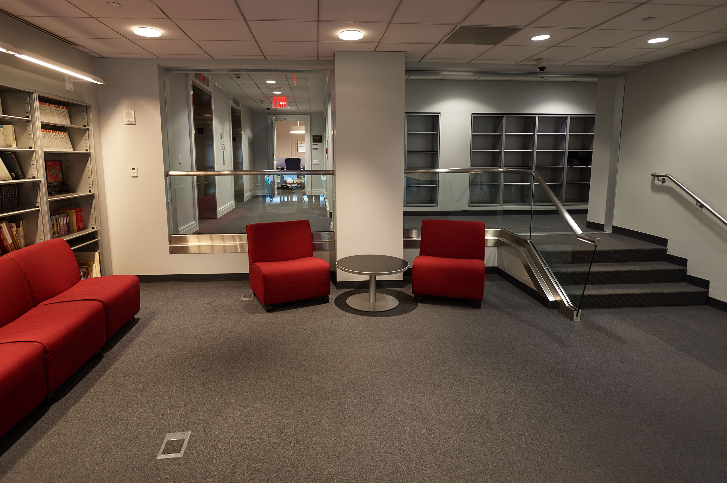 Common sitting area with red soft chairs in SUNY Global Center.