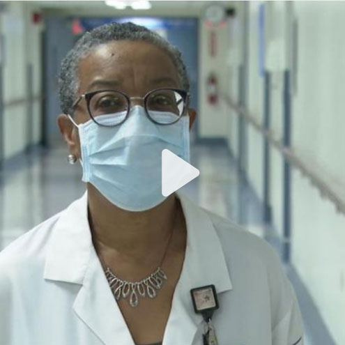 A video screenshot of a SUNY Downstate doctor in the hallway of the University Hospital.