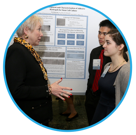 Chancellor Nancy Zimpher talks with two SUNY students during a student showcase at the Empire State Plaza.