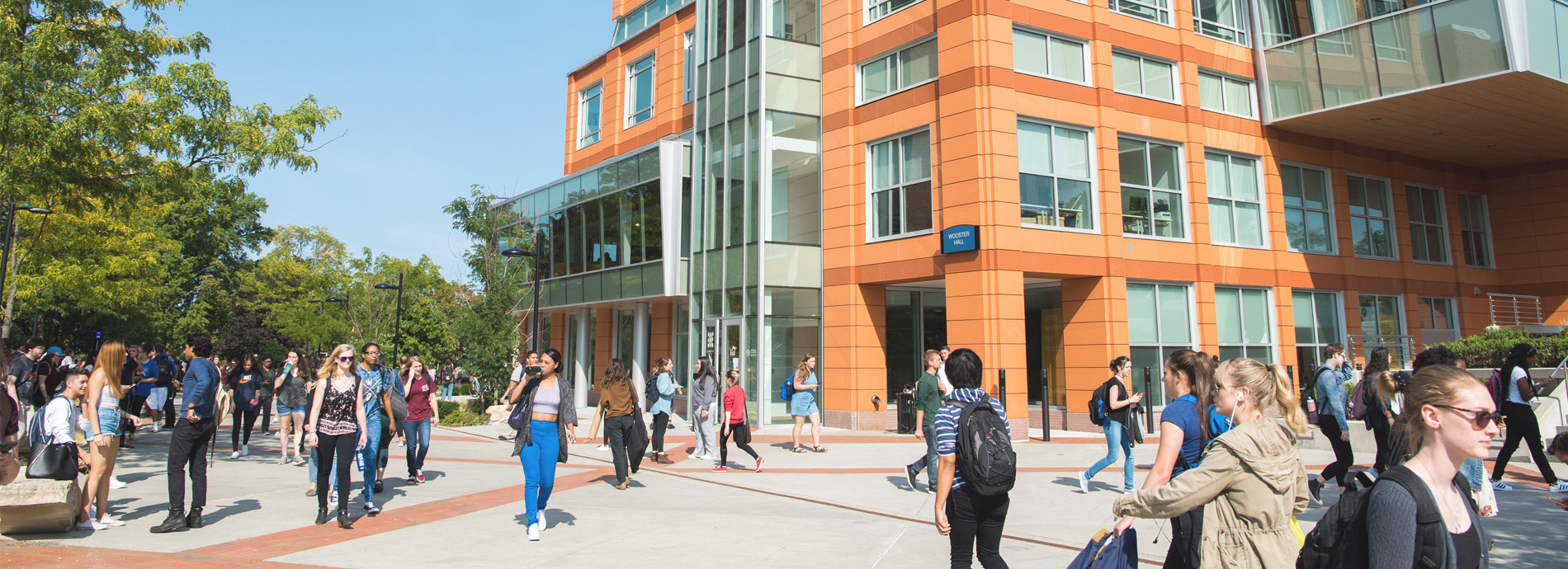 SUNY New Paltz campus quad with many students walking between buildings.