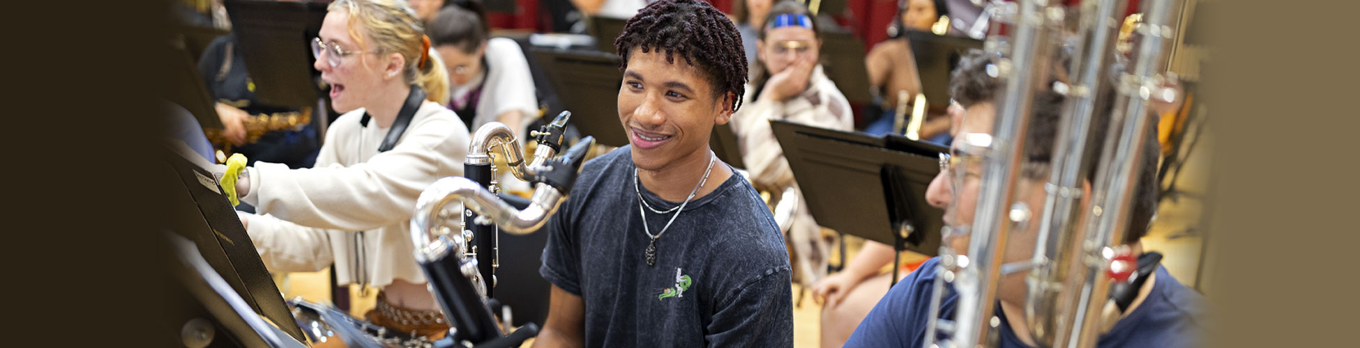 College students in the wind instrument section take a break during band practice.