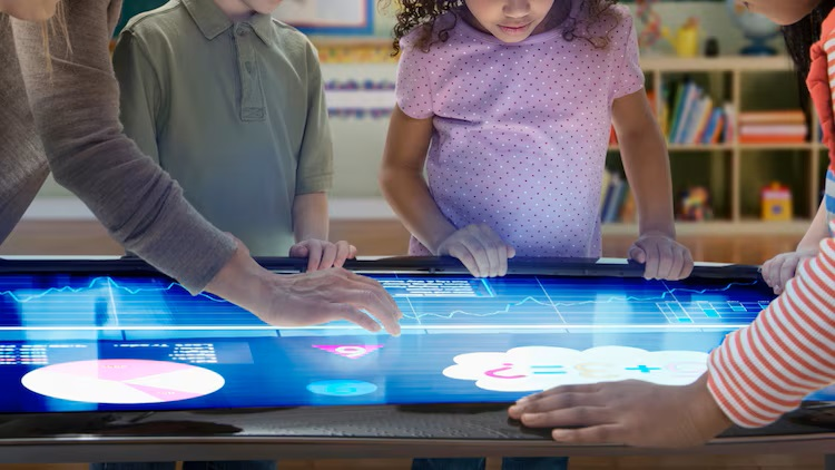 Students looking at video touch screen