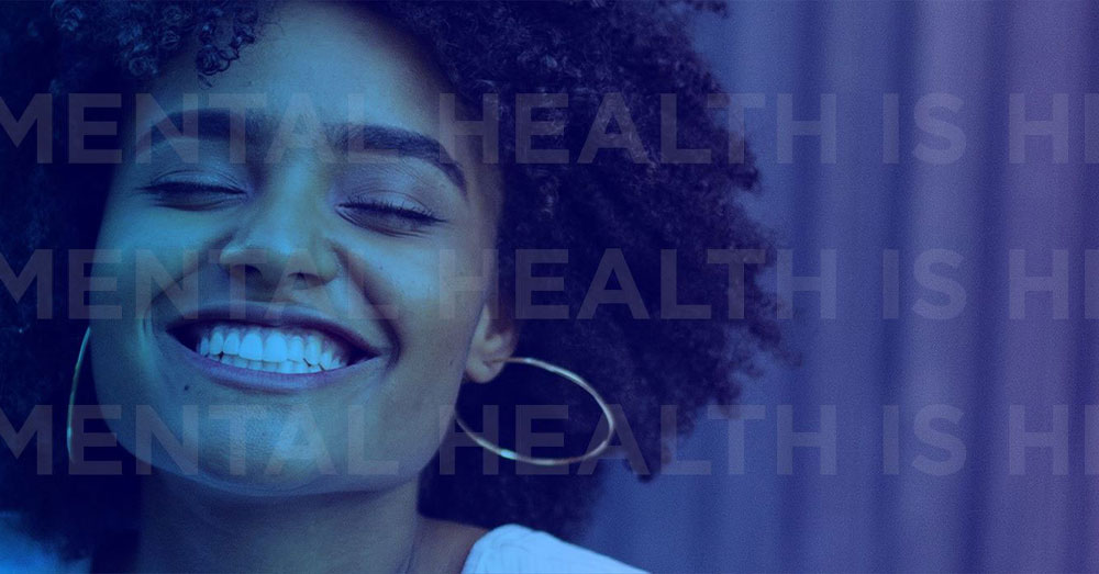 African American female smiles wide under a blue gradient color wash with Mental Health is Health written over the top.