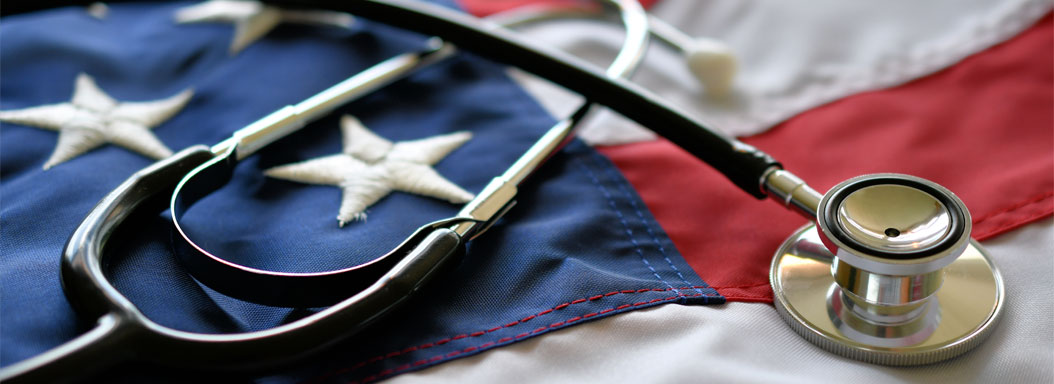 A stethoscope laying on top of an American Flag.