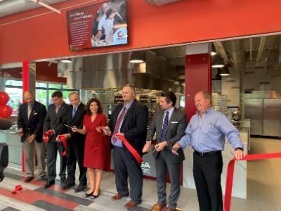 Ribbon cutting at the Cayuga Culinary Institute with Chancellor Malatras, Lieutenant Governor Hochul, and others.	