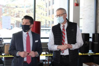 Chancellor Malatras stands with SUNY Plattsburgh president Enyedi while both wear facemasks.