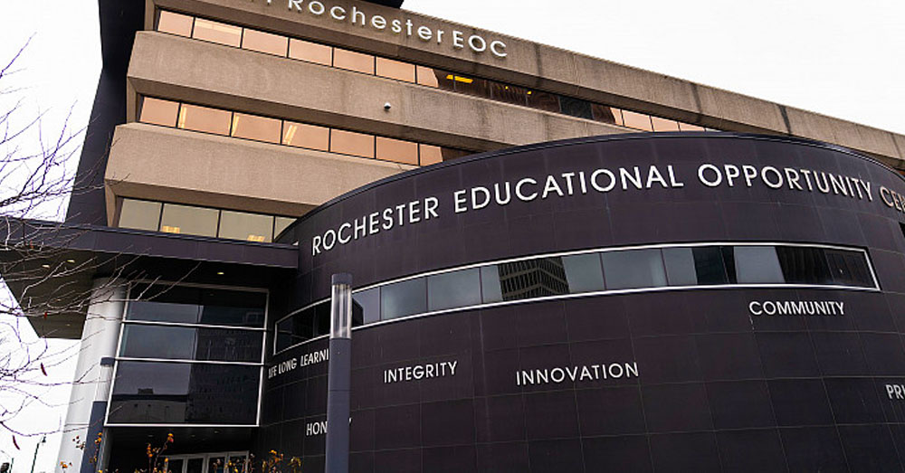 Front entrance of the Rochester Educational Opportunity Center with its name on the entryway.