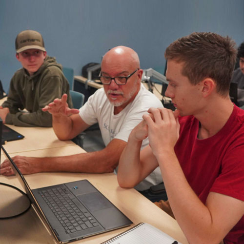 Taylor Zimmer works beside SUNY Morrisville renewable energy students who are designing a microgrid for his retreat farm. Photo courtesy Morning Ag Clips.