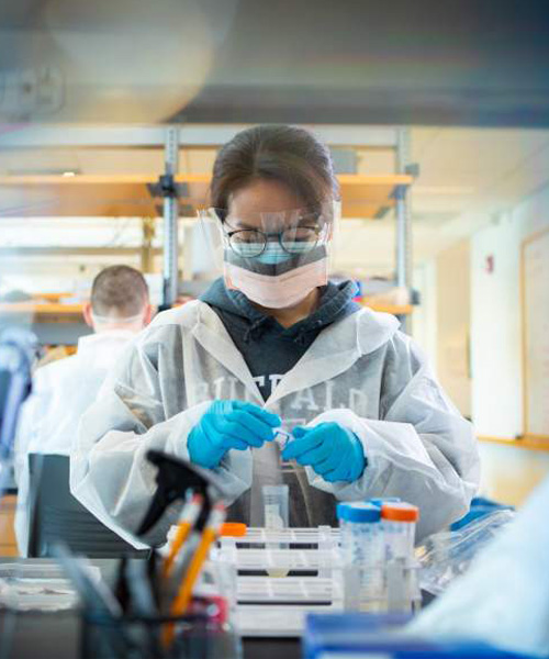 Biotech - UB - female with test tubes mask face protection