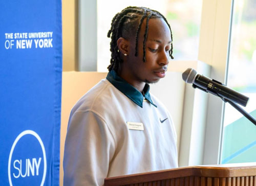 Shausé Gregoire of SUNY Morrisville speaks at a podium during an ASAP press event.
